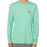 Front view of a male model wearing the Surfer Skeleton performance long sleeve tee in mint green on a white background. Accented with a hot pink double diamond shield over wearers left chest.