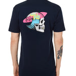 Back view of a male model wearing the Skull Wave Head Tee in navy. The back graphic features a skull with a wave inside the head, overlapped by a pink surfboard and accented with yellow and blue "Till I Die" text.
