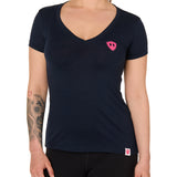 Front view of a female model wearing the Skull Wave Head V neck tee in mint green on a white background. Accented with a hot pink double diamond shield over wearers left chest.