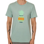 Front view of a male model wearing a dusty blue green short sleeve crew neck t-shirt with a vibrantly colored retro pineapple graphic on the front.