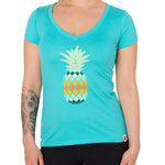 Front view of a female model wearing a Tahiti Blue short sleeve V neck t-shirt with a vibrantly colored retro pineapple graphic on the front.