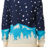 BACK OF A FEMALE MODEL WEARING A NAVY AND WHOTE SWEATER FEATURING SNOWY MOUNTAINS