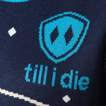 DETAIL OF A NAVY AND WHITE SWEATER FEATURING THE TILL I DIE SHIELD LOGO