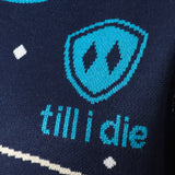DETAIL OF A NAVY AND WHITE SWEATER FEATURING THE TILL I DIE SHIELD LOGO