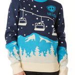 A woman wearing a navy and blue sweater with a snowy mountain and chairlift design.