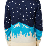 BACK OF A MALE MODEL WEARING A NAVY AND WHITE SWEATER WITH SNOWY MOUNTAIN GRAPHICS