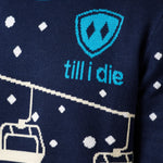 DETAIL OF A MALE WEARING A NAVY AND WHITE SWEATER WITH THE TILL I DIE SHIELD LOGO