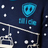 DETAIL OF A MALE WEARING A NAVY AND WHITE SWEATER WITH THE TILL I DIE SHIELD LOGO