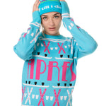 FEMALE MODEL WEARING A MATCHING TEAL AND PINK "APRES SKI" BEANIE AND SWEATER