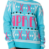 A woman wearing a blue and pink 'APRES SKI' themed knit sweater