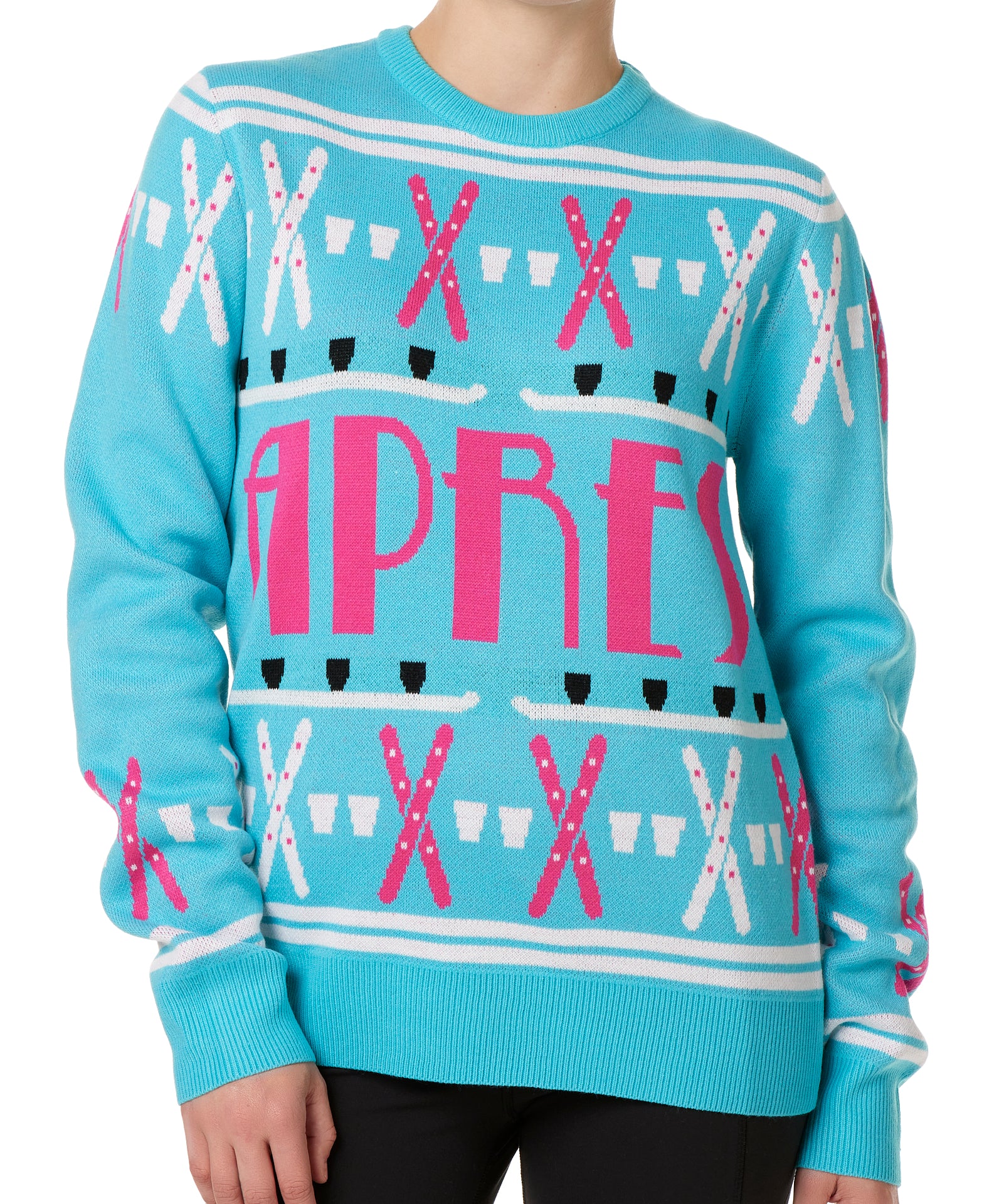 A woman wearing a blue and pink 'APRES SKI' themed knit sweater