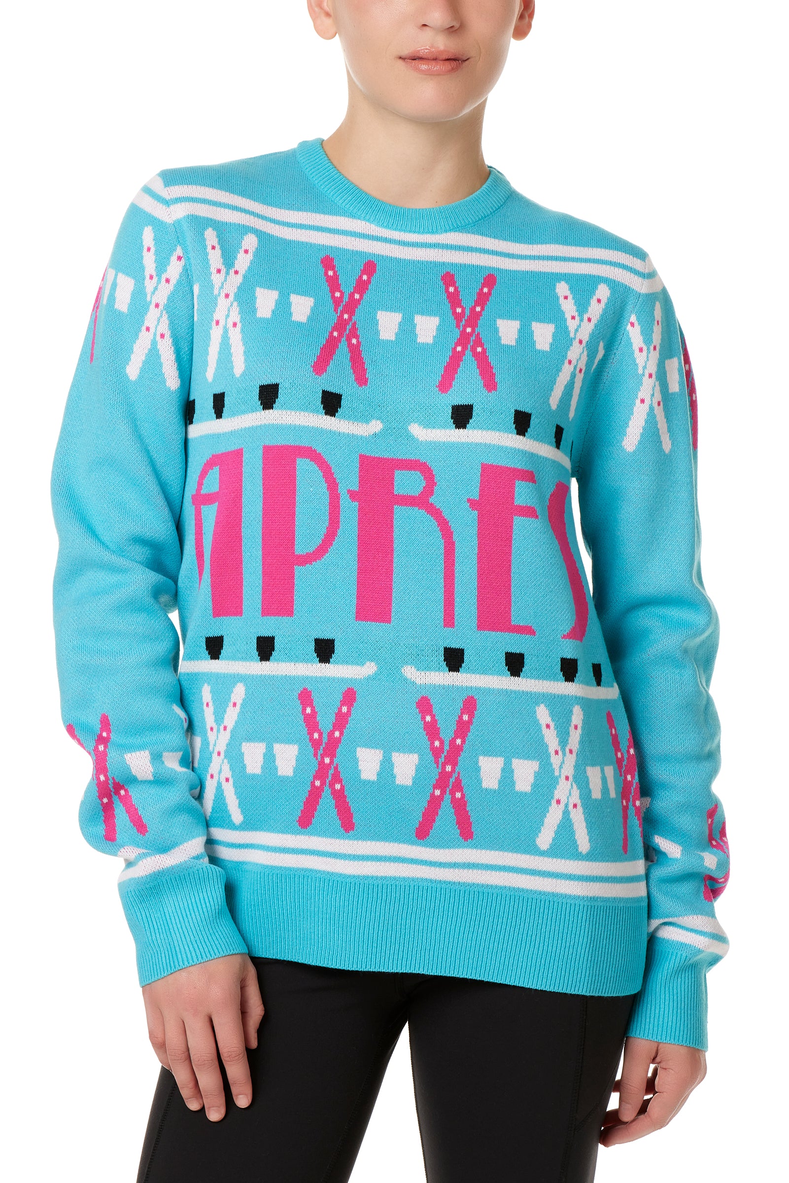 A woman wearing a blue and pink 'APRES SKI' themed knit sweater