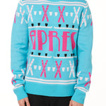 A male model wearing a TEAL AND PINK sweater with SHOT SKI GRAPHICS and the word 'APRES' written across the front.