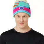 A MAN wearing a multicolored beanie with a pink pom-pom on top, featuring a TILL I DIE brand patch on the fold THAT SAYS "DO WHAT YOU LOVE. DO IT FOREVER."