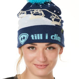 FEMALE MODEL WEARING A NAVY AND WHITE HAT WITH A BLUE POM POM AND CHAIRLIFT GRAPHIC WITH THE WORD "TILL I DIE" ON THE FOLD