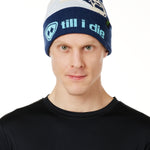 MALE MODEL WEARING A NAVY AND WHITE HAT WITH A BLUE POM POM AND CHAIRLIFT GRAPHIC WITH THE WORD "TILL I DIE" ON THE FOLD