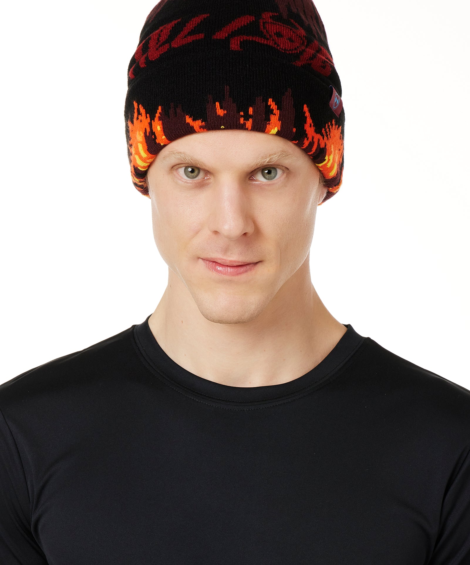 A MALE MODEL WEARING A BEANIE HAT WITH FLAMES AND THE WORDS "TILL I DIE"