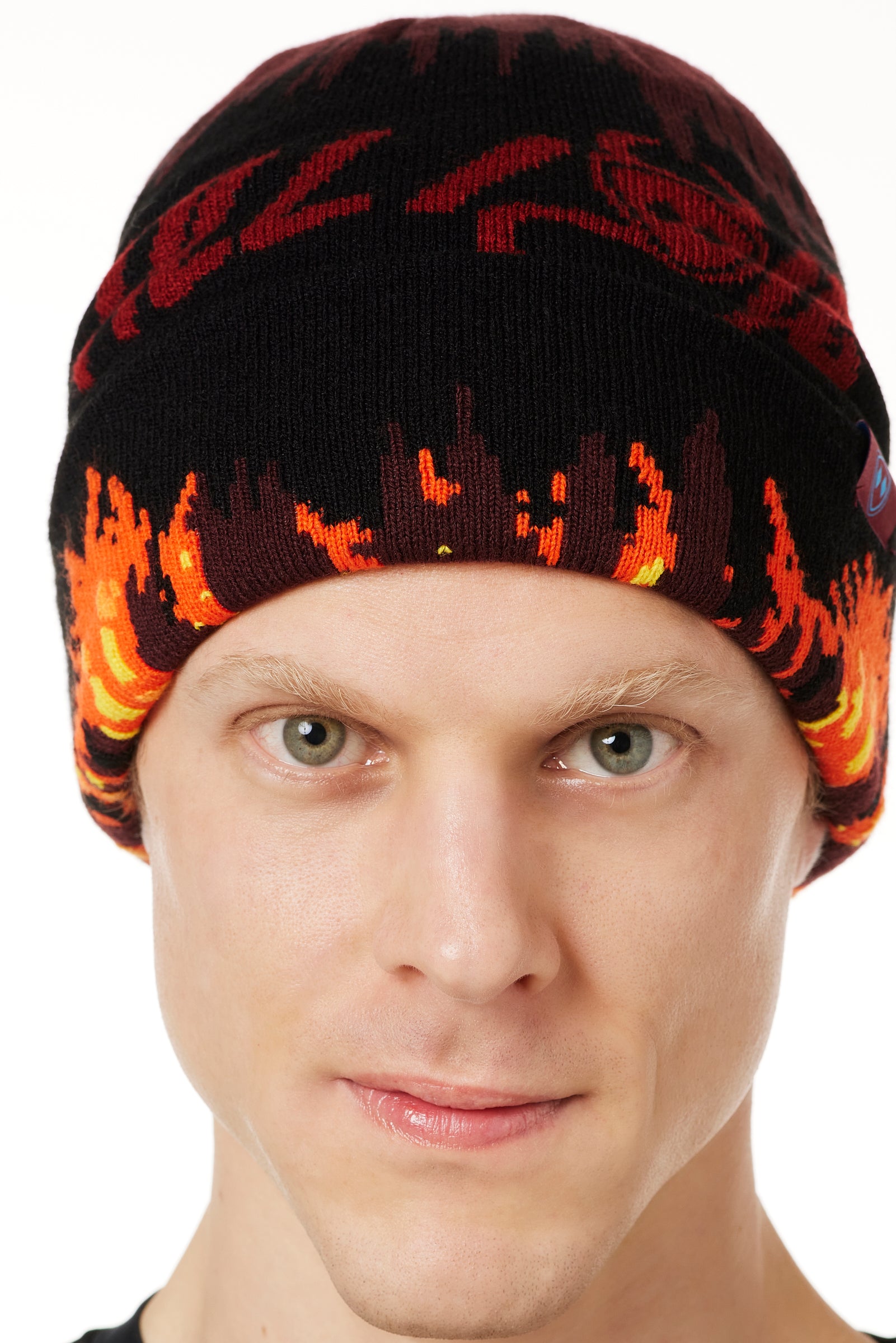 DETAIL OF A MALE MODEL WEARING A BEANIE HAT WITH FLAMES AND THE WORDS "TILL I DIE"