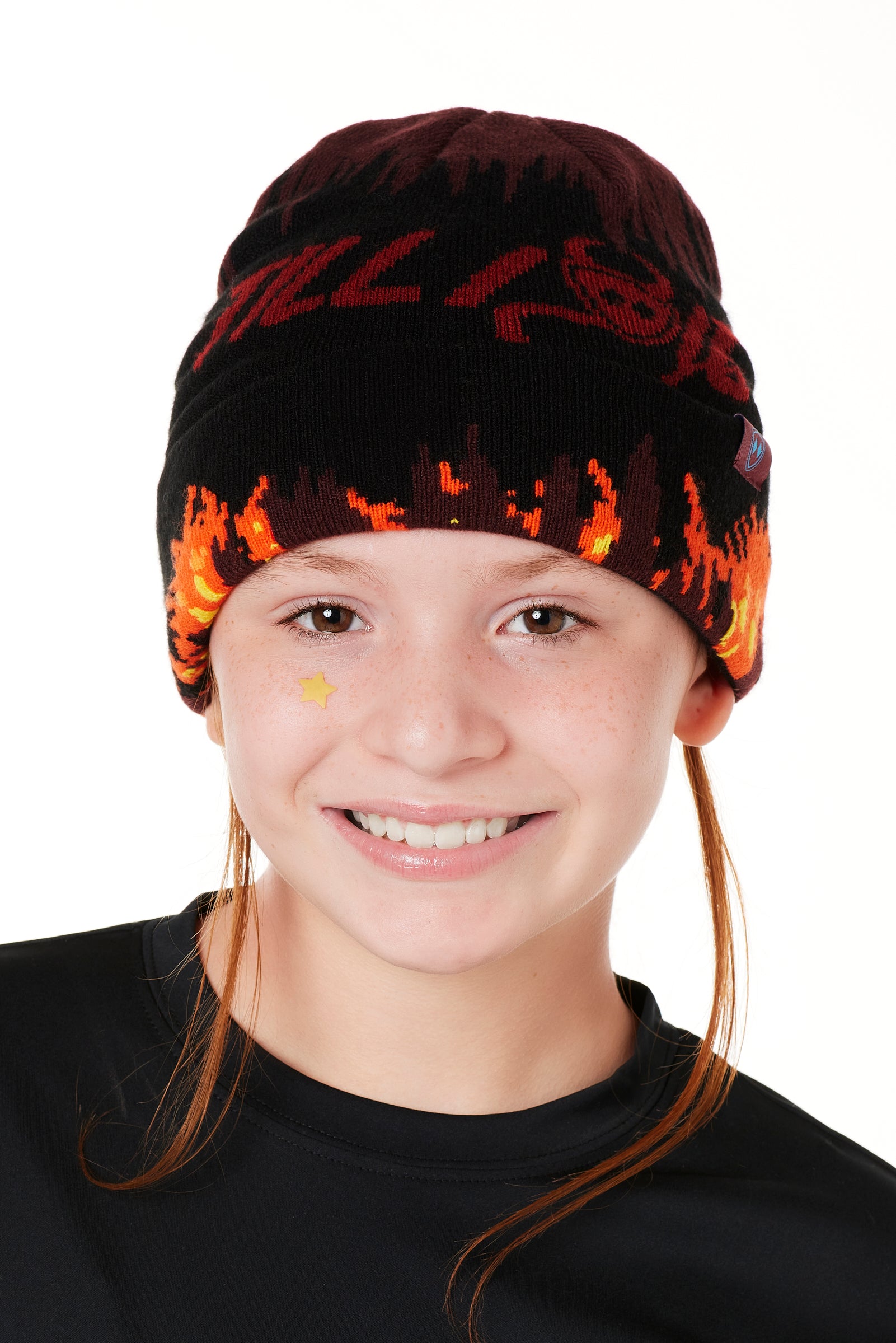 A YOUTH MODEL WEARING A BEANIE HAT WITH FLAMES AND THE WORDS "TILL I DIE"