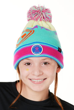 A YOUTH wearing a multicolored beanie with a pink pom-pom on top, featuring a TILL I DIE brand patch on the fold THAT SAYS "DO WHAT YOU LOVE. DO IT FOREVER."