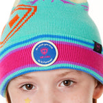 DETAIL OF A YOUTH wearing a multicolored beanie with a pink pom-pom on top, featuring a TILL I DIE brand patch on the fold THAT SAYS "DO WHAT YOU LOVE. DO IT FOREVER."