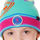 DETAIL OF A YOUTH wearing a multicolored beanie with a pink pom-pom on top, featuring a TILL I DIE brand patch on the fold THAT SAYS "DO WHAT YOU LOVE. DO IT FOREVER."