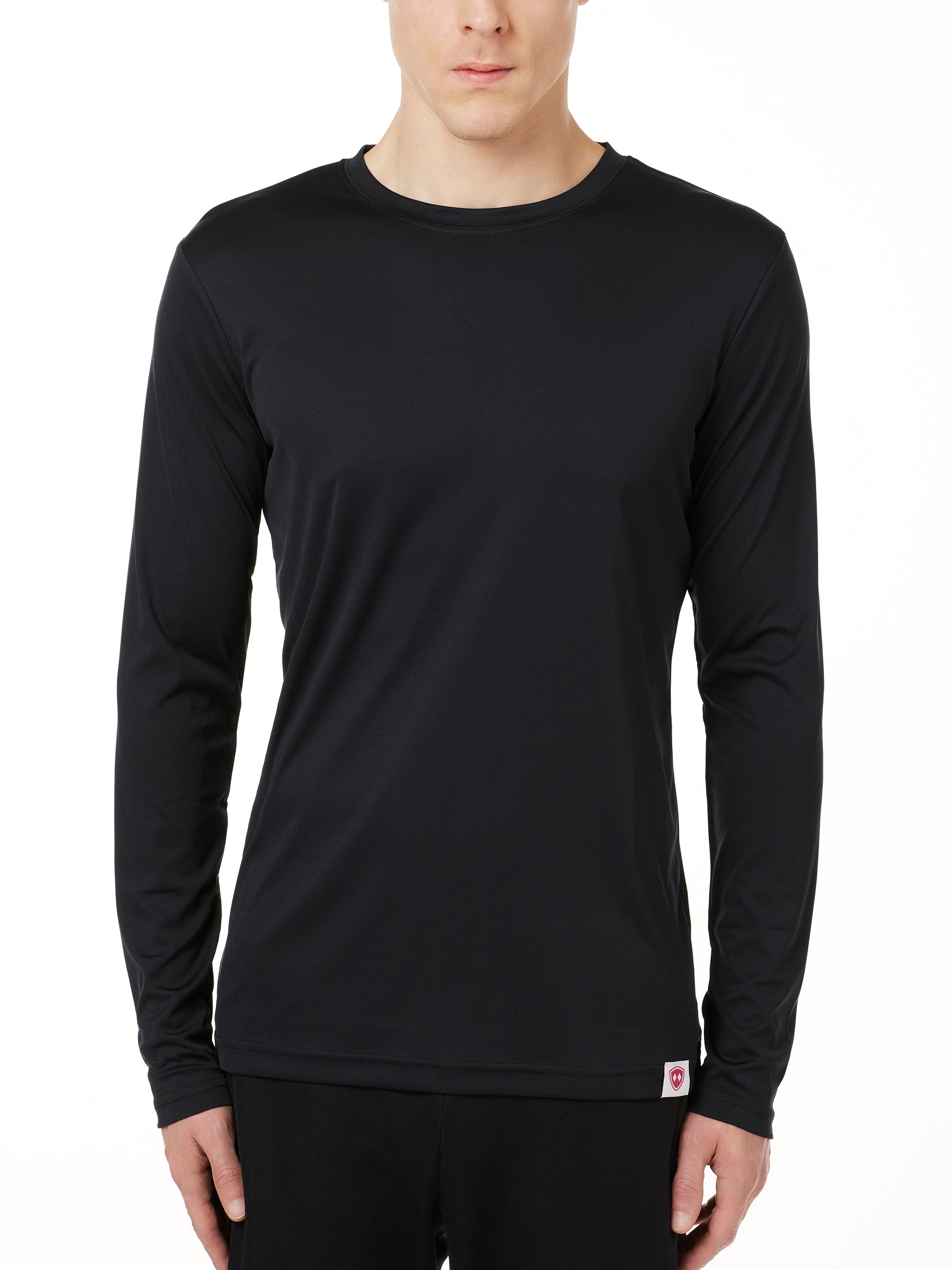 MALE MODEL WEARING A BLACK LONG SLEEVE PERFORMANCE LAYER