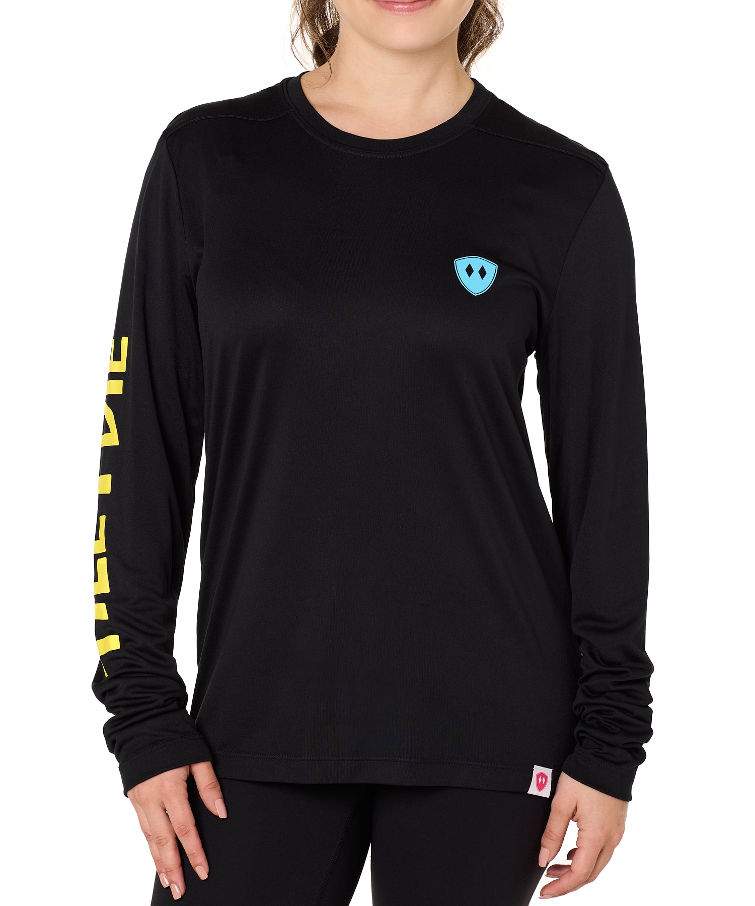 Front view of a female model wearing the Gear Head performance long sleeve tee in black on a white background. Accented with a cyan blue double diamond shield over wearers left chest.