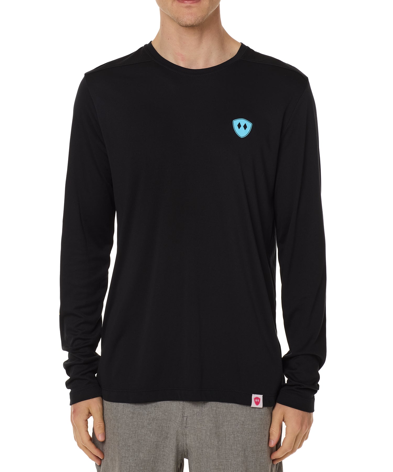 Front view of a male model wearing the Gear Head performance long sleeve tee in black on a white background. Accented with a cyan blue double diamond shield over wearers left chest.