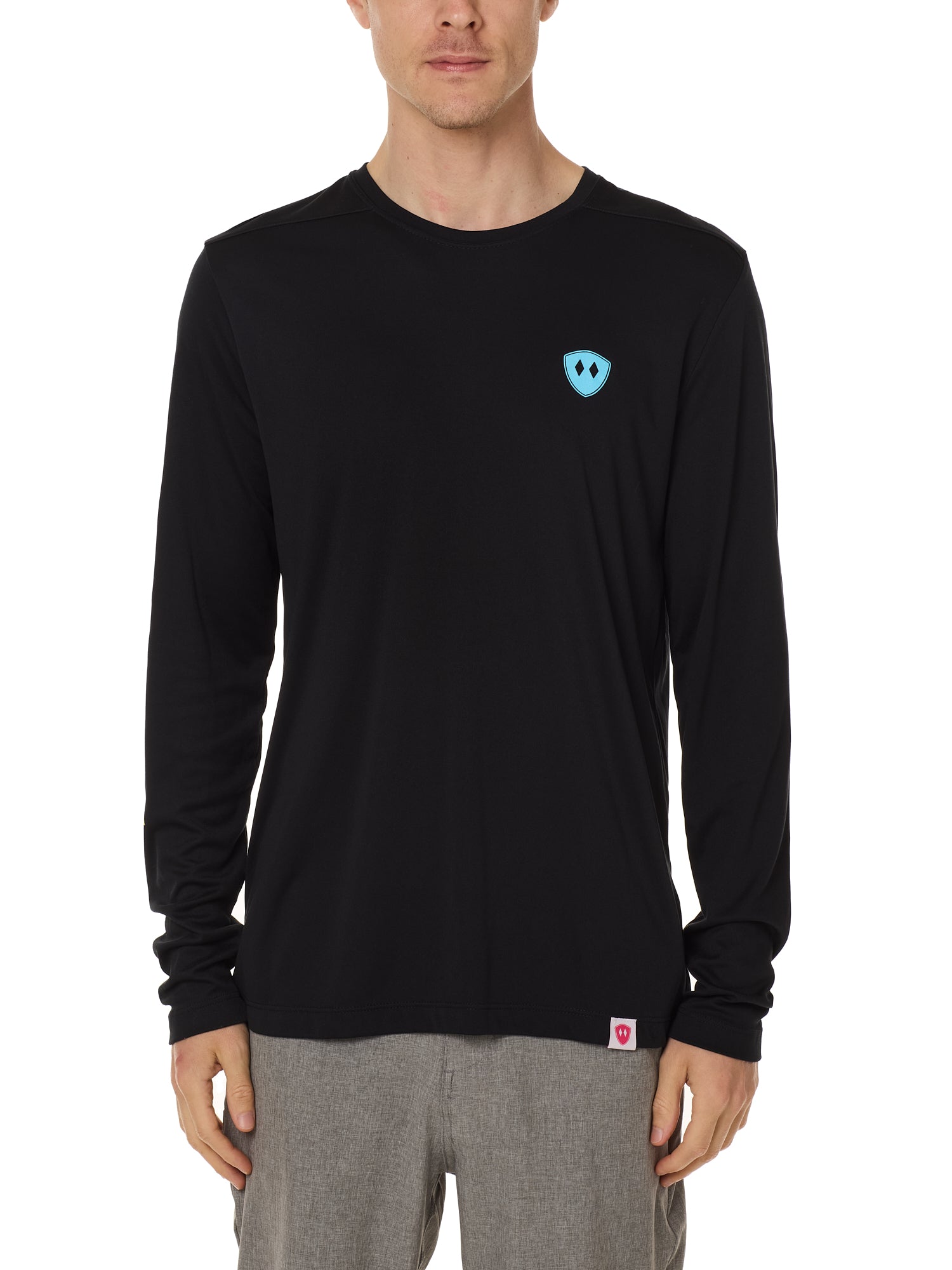 Front view of a male model wearing the Gear Head performance long sleeve tee in black on a white background. Accented with a cyan blue double diamond shield over wearers left chest.