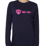 front view of a female model wearing a navy blue long sleeve tee with a hot pink till i die logo across the chest