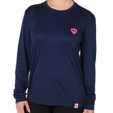 Front view of a female model wearing the Skull Wave Head performance long sleeve tee in Navy on a white background. Accented with a hot pink double diamond shield over wearers left chest.