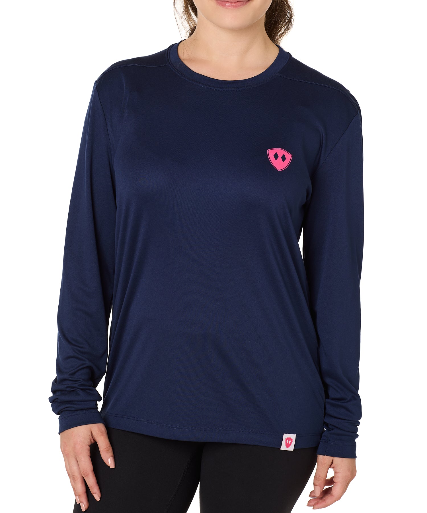 Front view of a female model wearing the Skull Wave Head performance long sleeve tee in Navy on a white background. Accented with a hot pink double diamond shield over wearers left chest.