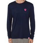 Front view of a male model wearing the Skull Wave Head performance long sleeve tee in Navy on a white background. Accented with a hot pink double diamond shield over wearers left chest.