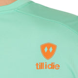 back detail of a mint green performance long sleeve accented with an orange till i die logo