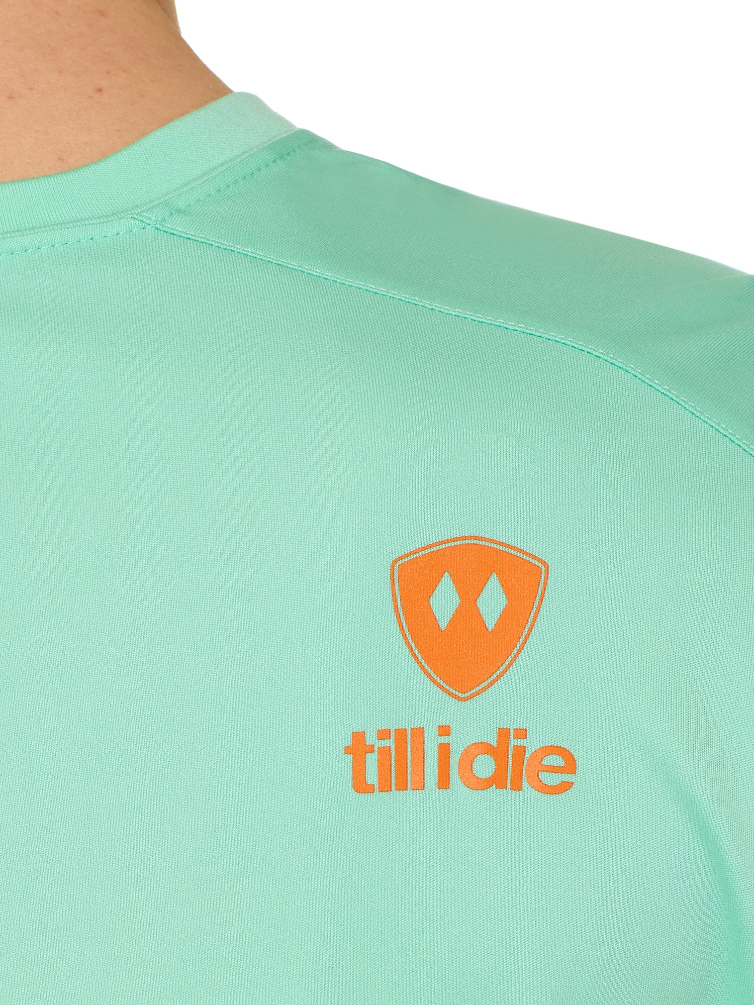 back detail of a mint green performance long sleeve accented with an orange till i die logo