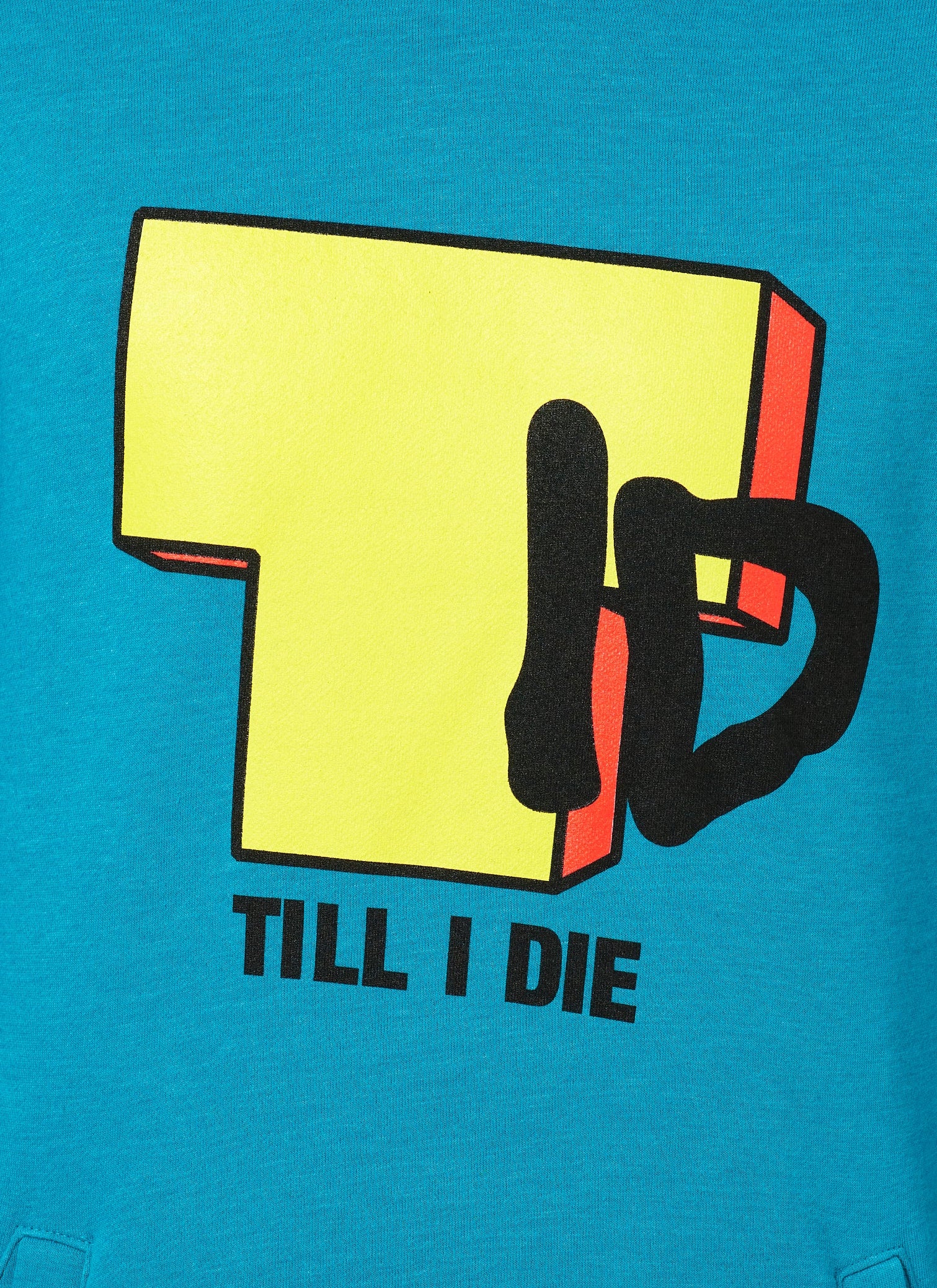 DETAIL OF A TEAL HOODIE FEATURING A BRIGHT YELLOW "T" WITH BLACK "I" AND "D", WITH TEXT BELOW IN BLACK SAYING "TILL I DIE"