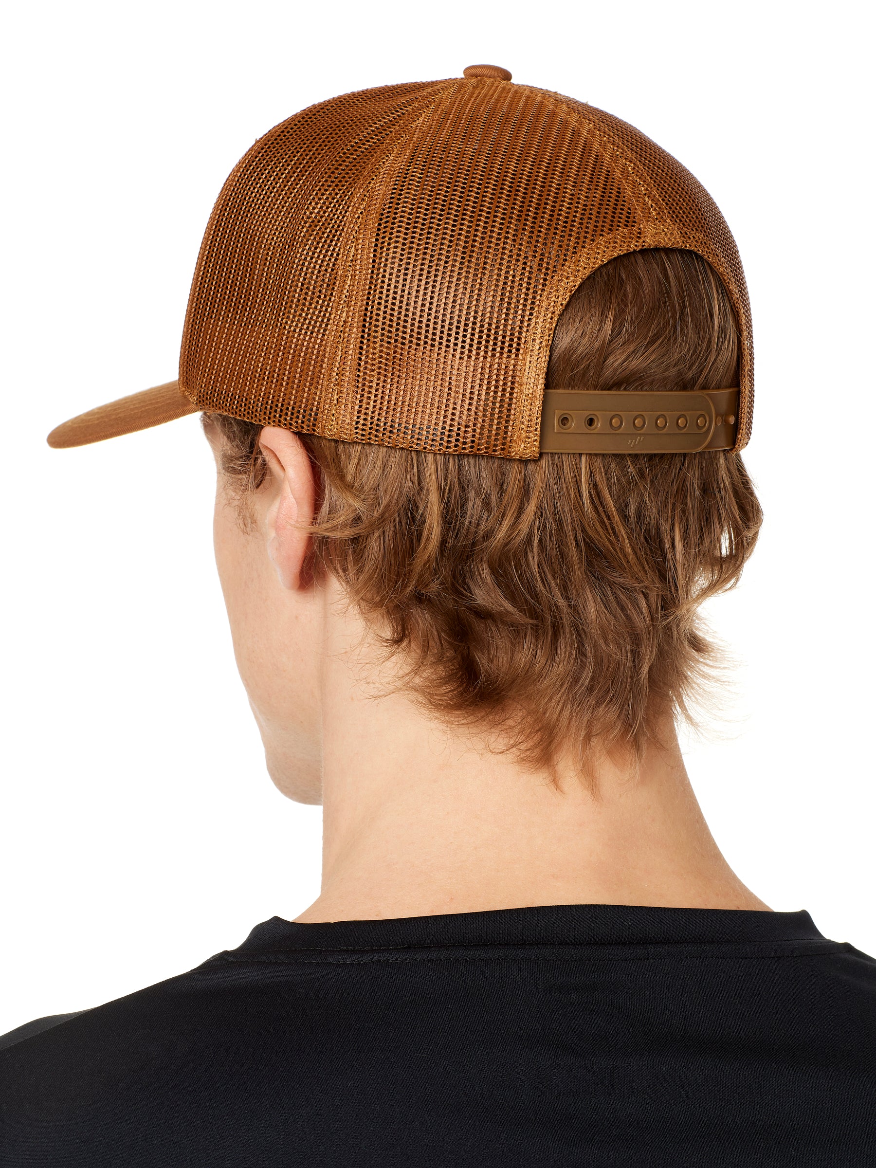 back view of a male model wearing a caramel classic trucker hat showing the mesh back panels and matching snapback closure