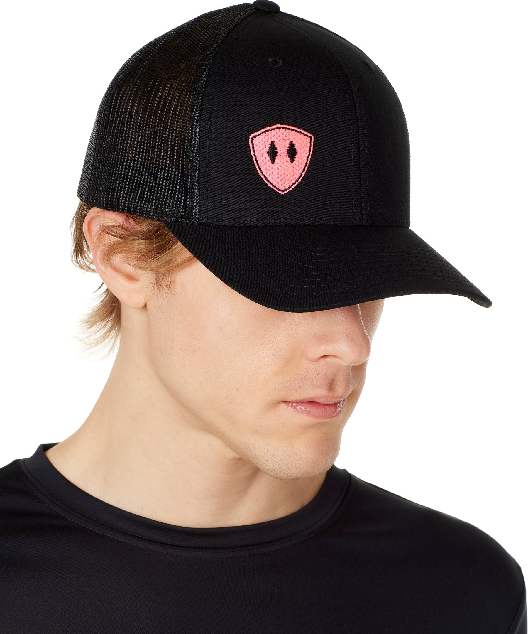Front view of a male wearing a black classic trucker hat with a pink embroidered double diamond shield on the bottom right panel