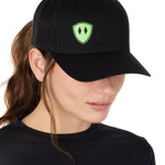 Front view of a female wearing a black classic trucker hat with a lime embroidered double diamond shield on the bottom right panel