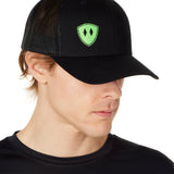 Front view of a male wearing a black classic trucker hat with a lime embroidered double diamond shield on the bottom right panel