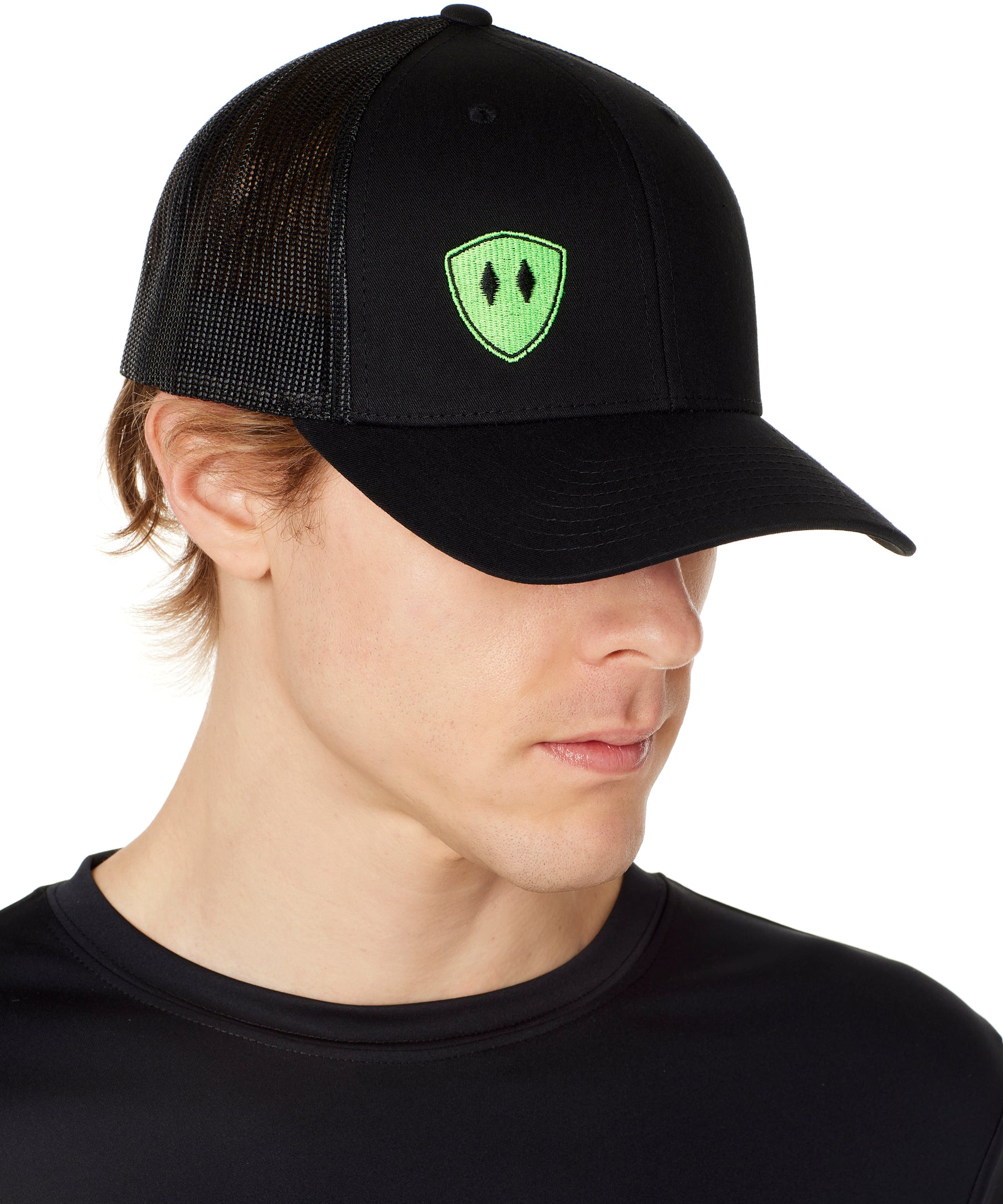 Front view of a male wearing a black classic trucker hat with a lime embroidered double diamond shield on the bottom right panel