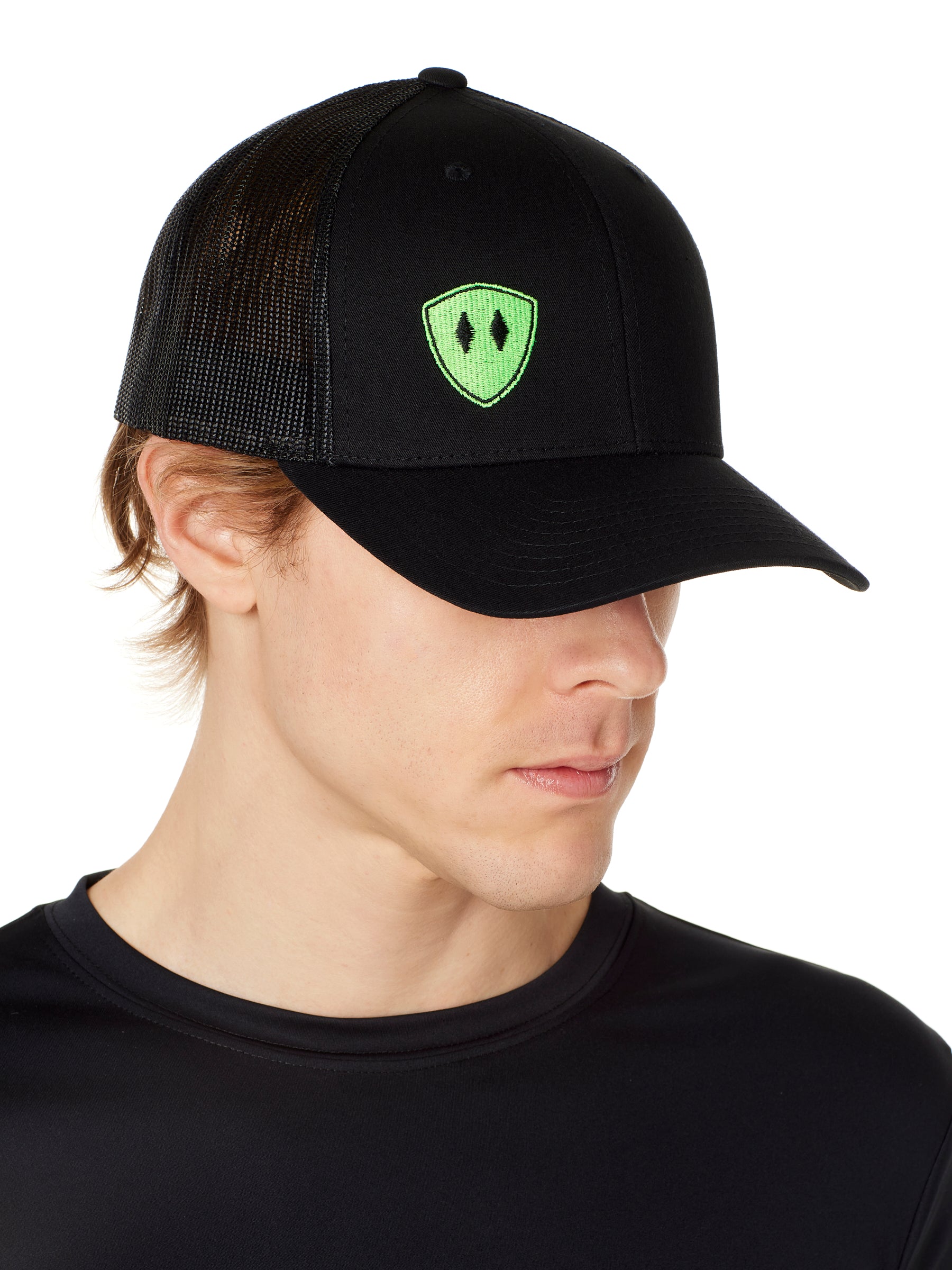 Front view of a male wearing a black classic trucker hat with a lime embroidered double diamond shield on the bottom right panel