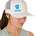 Front view of a female model wearing a white classic trucker hat, featuring a blue embroidered Till I Die logo on the lower right front panel.