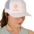 Front view of a female model wearing a white classic trucker hat, featuring a coral embroidered Till I Die logo on the lower right front panel.