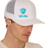 Front view of a male model wearing a white classic trucker hat, featuring a teal embroidered Till I Die logo on the lower right front panel.