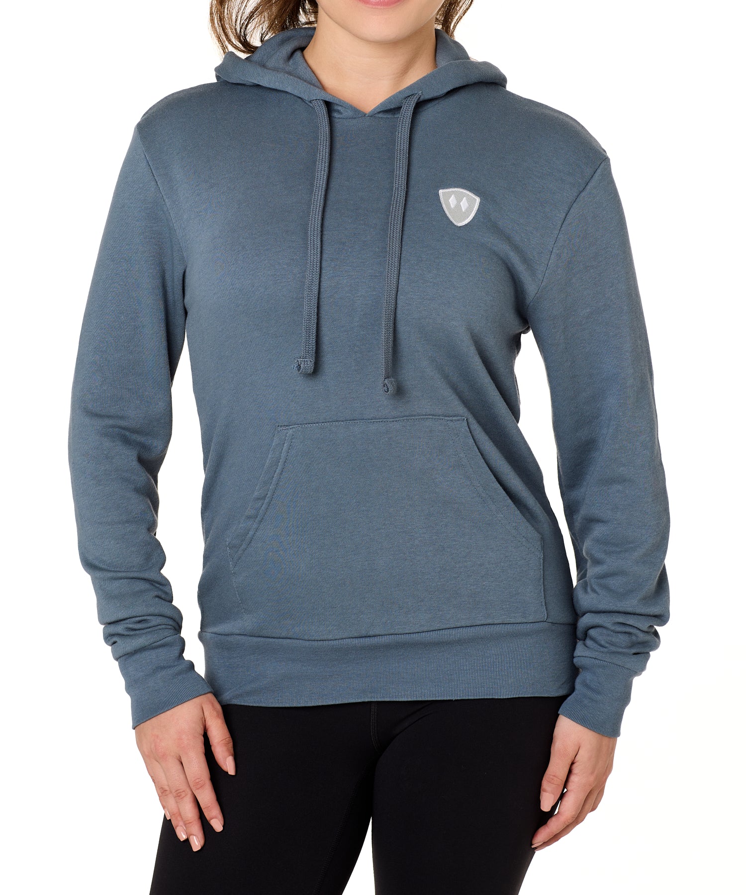 Front view of a female model wearing the Summer night hoodie in washed denim on a white background. The hoodie is embroider with a gray and white  double diamond shield over the wearers left chest.