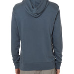 Back view of a male model wearing the Summer night hoodie in washed denim on a white background. Featuring a hood with fabric dyed to match fro a cohesive look.