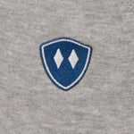 detail of a heather gray jogger embroidered with a blue and white double diamond shield