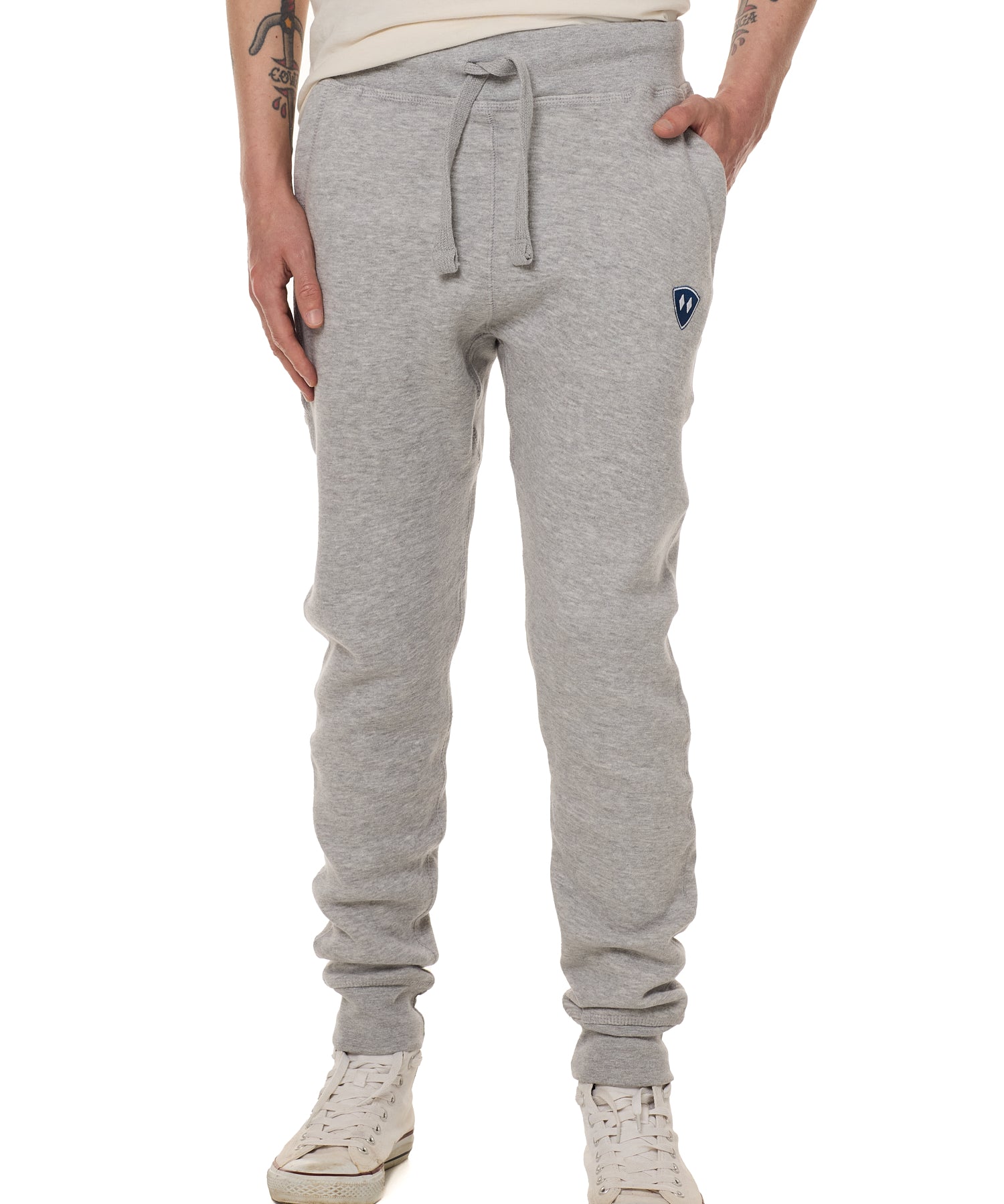 Front view of a male model wearing the Men's summer night heather gray joggers. The joggers have a dyed to match drawstring and navy and white embroidered double diamond logo near the left pocket.